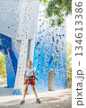 Young Boy Ready for Adventure at Outdoor Climbing Wall 134613386