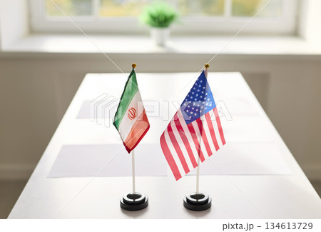 Iran and USA table flags set for diplomatic meeting on bright conference desk 134613729