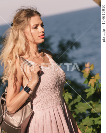 Hippie woman with backpack walking outdoor 134613910
