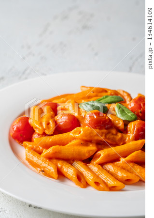 Penne pasta with roasted bell pepper emulsion cherry tomatoes Parmesan and herbs 134614109