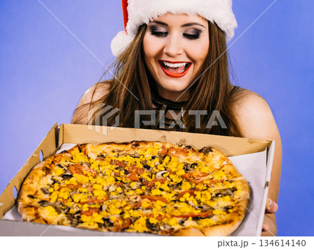 Christmas woman holds pizza in box Christmas woman holds pizza in box 134614140