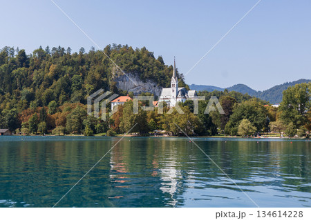 Old church in the hills with forest near Lake Bland. Summer travel and vacation. Amazing view of the landscape. Travel in Slovenia 134614228