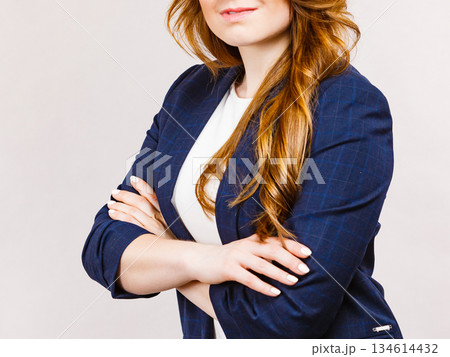 Business woman in suit folded arms 134614432