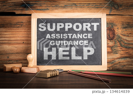 Support Concept. Chalkboard on a wooden office desk 134614839