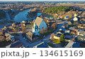 Porvoo, Finland - December 08, 2020: Aerial perspective of a picturesque village featuring a historic church and winding river, surrounded by lush greenery and colorful houses 134615169