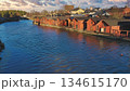 Porvoo, Finland - December 08, 2020: Scenic view of a river lined with charming red wooden houses, reflecting on the water surface under a beautiful sky 134615170