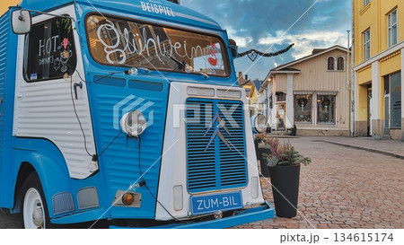 Porvoo, Finland - December 08, 2020: Blue Citroen food truck is parked on a cobblestone street, surrounded by quaint buildings, creating a vibrant and inviting atmosphere Porvoo, Finland - December 08, 2020: Blue Citroen food truck is parked on a cobblestone street, surrounded by quaint buildings, creating a vibrant and inviting atmosphere 134615174
