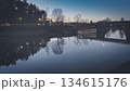 Porvoo, Finland - December 08, 2020: Scenic view of a river at dusk, showcasing reflections of trees and lights along the water, creating a tranquil evening atmosphere 134615176