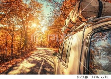 Scenic Autumn Road Trip with Electric Vehicle Surrounded by Colorful Fall Foliage Scenic Autumn Road Trip with Electric Vehicle Surrounded by Colorful Fall Foliage 134617710
