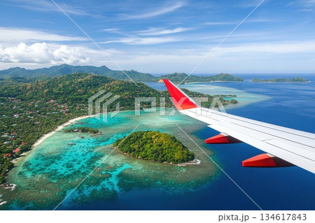Breathtaking View from Airplane Window Seat over Turquoise Waters and Islands Breathtaking View from Airplane Window Seat over Turquoise Waters and Islands 134617843