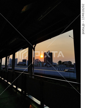 Vibrant sunset over city skyline and highway with architectural silhouette 134618202