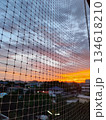 Beautiful sunset sky through a window net with city silhouette 134618210