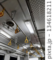 Interior of an old train with retro fans and yellow straps 134618211