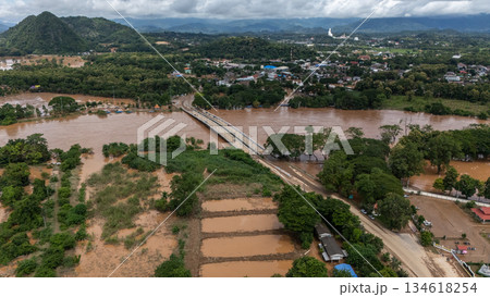 Aerial view of suburb area in Chiang Rai province flooding by Kok river after typhoon Yagi has swept Southeast Asia. 134618254