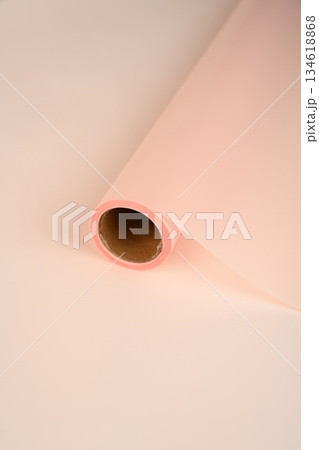 Rolled floral wrapping paper in soft peach tones. Pastel blush apricot and light coral color material for bouquets gift wrapping and flower shop decor. 134618868
