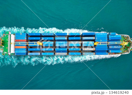 Shipping logistics. Commercial shipping. Cargo ship in sea, aerial view. Massive cargo ship. Freight container loaded on vessel. Aerial view cargo ship entering harbor. Cargo business. Container ship 134619240