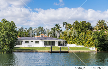 Vacation building in summer. Luxury waterfront house. Hotel building. Residential architecture. Modern building. Residential apartment in waterfront city. Waterfront landscape with house 134619286