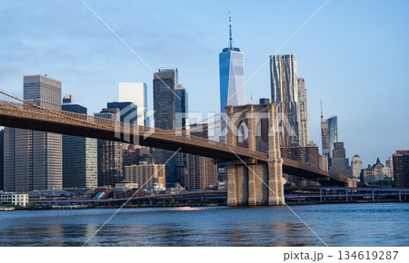 Brooklyn bridge leads to Manhattan. Urban architecture of New York city. Brooklyn bridge of New York city. Brooklyn landmark. Manhattan cityscape with skyscraper architecture 134619287