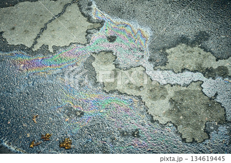 Iridescent oil slick creating abstract rainbow colors on asphalt 134619445