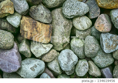 Natural rock wall showing rough stone texture Natural rock wall showing rough stone texture 134619456