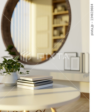 Books on white round stool table on wooden floor of a living room with circular door to library. 134619664