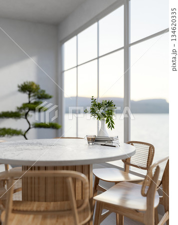 A glass cup of coffee and glasses with books atop marble table with wooden chairs in a white living room. 134620335