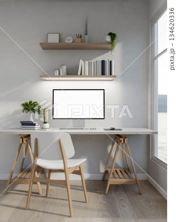 White screen computer with books and a wooden figure aside on white table in a clean bright room. 134620336