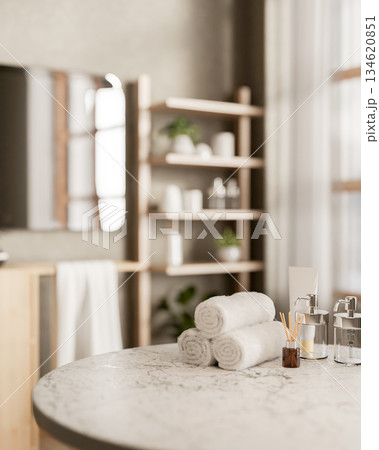Towels and a diffuser with pump bottles and tube aside on round marble table in modern spa bathroom. Towels and a diffuser with pump bottles and tube aside on round marble table in modern spa bathroom. 134620851