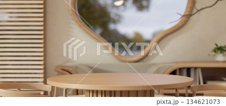 Empty round table and armchairs in a dining room or a cafe with odd shaped window and wooden blinds. Empty round table and armchairs in a dining room or a cafe with odd shaped window and wooden blinds. 134621073