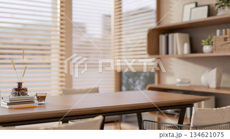 Glass of coffee and book aside flower vase on wooden table in living room or cafe with stylish shelf Glass of coffee and book aside flower vase on wooden table in living room or cafe with stylish shelf 134621075