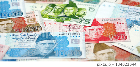 Pakistan rupees banknotes. The current Pakistan money bills lies on table in big amount. The concept of business and investment in Pakistan Pakistan rupees banknotes. The current Pakistan money bills lies on table in big amount. The concept of business and investment in Pakistan 134622644