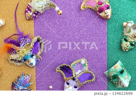 A group of venetian, mardi gras mask or disguise on a colorful glitter background close up 134622699