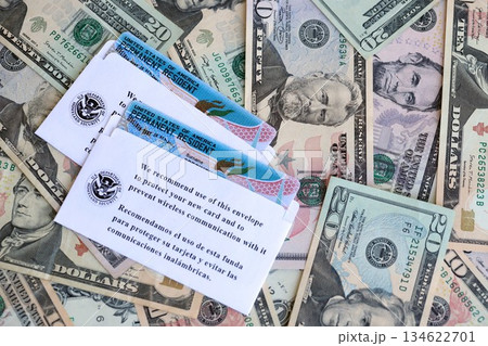 Permanent resident green cards lies on many dollar bills close up 134622701