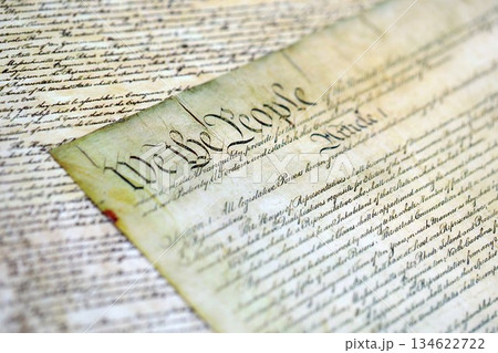 A parchment of the Constitution of the United States. We the people, the beginning of the preamble to the United States constitution close up A parchment of the Constitution of the United States. We the people, the beginning of the preamble to the United States constitution close up 134622722