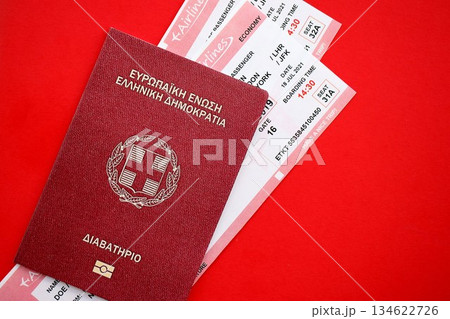 Greece passport and commercial airlines boarding pass tickets close up. Travel flights and avia tourism in Europe concept 134622726
