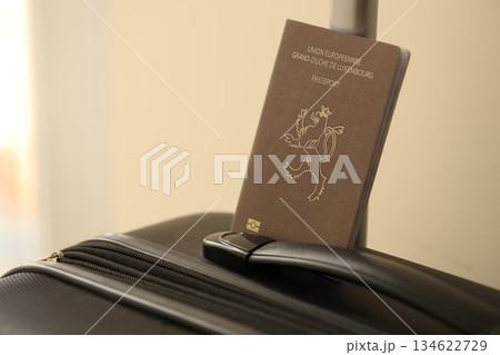 Luxembourg passport on touristic baggage luggage in airport close up. Travel and tourism in Europe concept 134622729