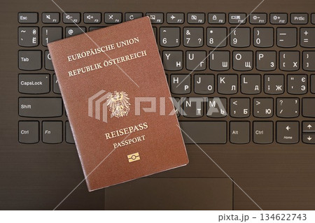 Austria passport lies on black laptop keyboard buttons background close up. Technologies and control in Europe concept 134622743