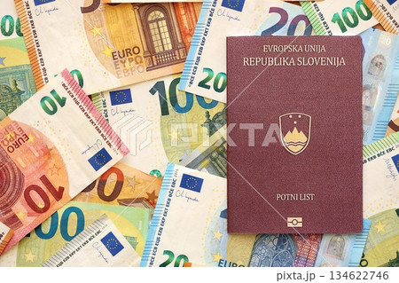 Slovenia passport lies on big amount of euro money banknotes close up. Rich life and travel in Europe concept 134622746