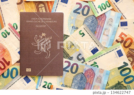 Luxembourg passport lies on big amount of euro money banknotes close up. Rich life and travel in Europe concept Luxembourg passport lies on big amount of euro money banknotes close up. Rich life and travel in Europe concept 134622747
