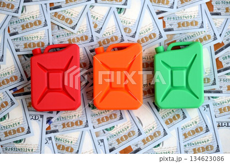 Petroleum canister lies on big amount of dollar bills. Concept of petrol prices in United States 134623086