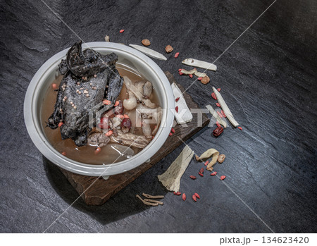 A revered staple in Chinese and Asian culinary traditions, the nourishing health stew pictured is widely celebrated as "Black Chicken Soup" also known as Stewed Black Bone Chicken or silkie chicken 134623420