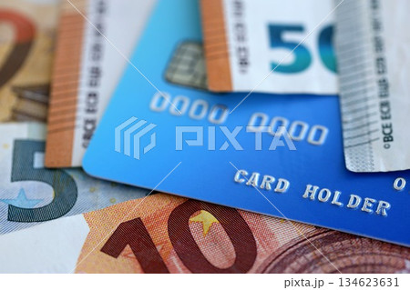 Euro money bills banknotes and credit card for cashless payments. Concept of banking service in European Union countries 134623631