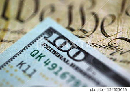 One hundred US dollar bills and United States Constitution page fragment. Concept of lawsuit and bribery in United States One hundred US dollar bills and United States Constitution page fragment. Concept of lawsuit and bribery in United States 134623636