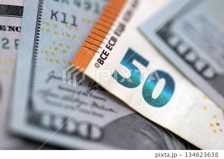 One hundred US dollar bill banknotes and fifty european Euro currency banknote. Concept of currency exchange between USD and EUR 134623638