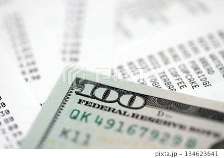 Money lose change after store visit with the store receipt. Supermarket check receipt and one hundred dollar bill close up 134623641