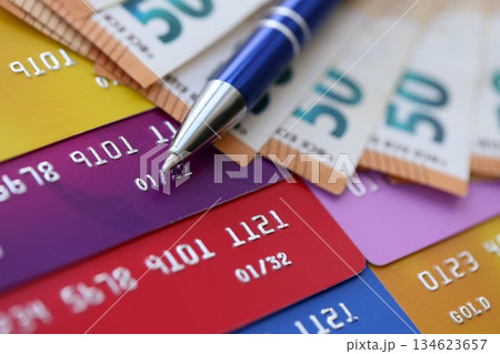 Credit cards and pen with euro currency money bills banknotes. Business, financial operations and accounting in European Union Credit cards and pen with euro currency money bills banknotes. Business, financial operations and accounting in European Union 134623657