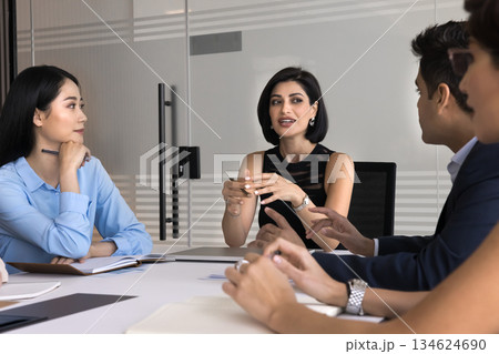 Professional businesslady hold meeting with staff gathered at conference table Professional businesslady hold meeting with staff gathered at conference table 134624690