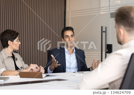 Marketing department discussing ideas, evaluating market trends during meeting 134624709