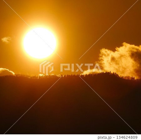 山の陰に沈む太陽のシンプルな風景 134624809