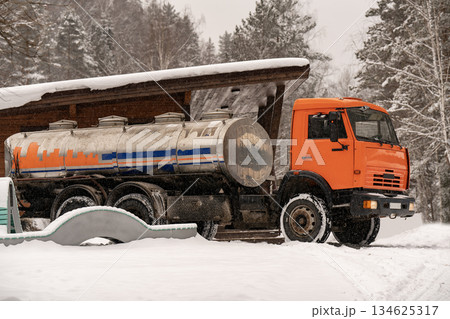 Truck with a tank for water delivery in winter. Truck with a tank for water delivery in winter. 134625317